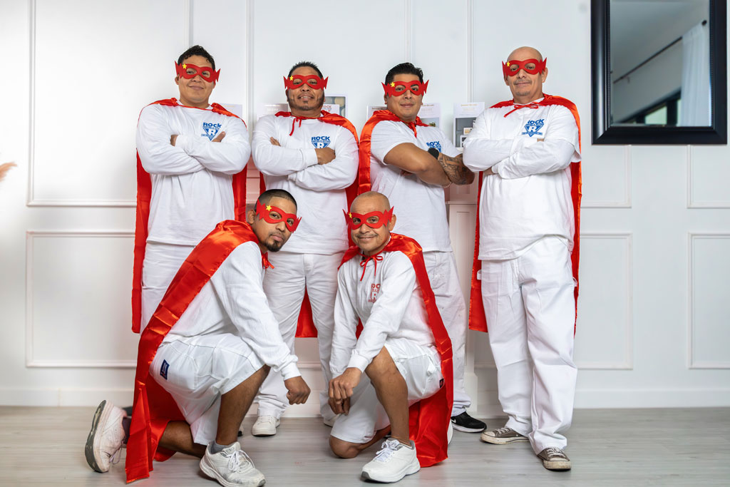 Photo of the ROCK Painting and Gutters Crew wearing superhero outfits